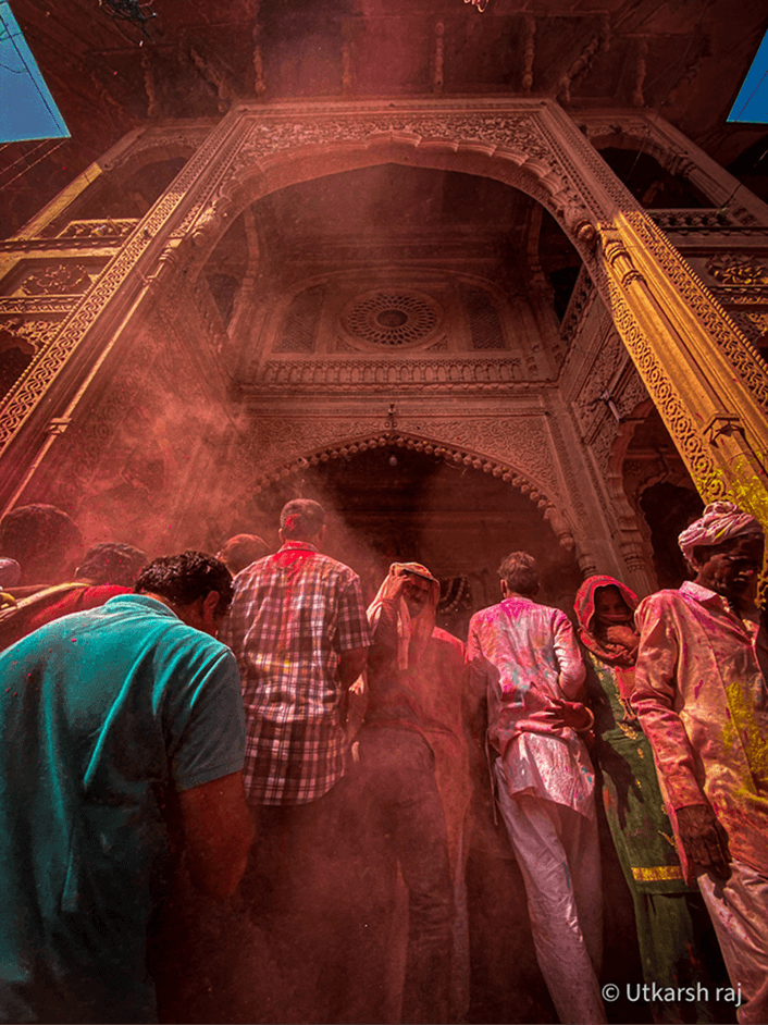 Holi colour burst inside an ornate temple