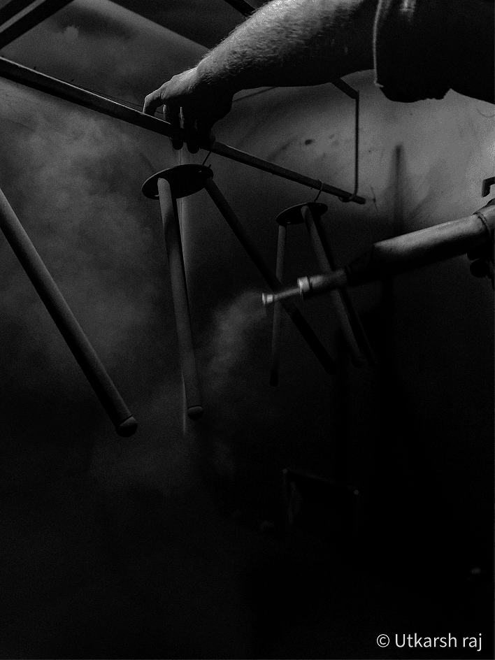 Overhead black and white view of a bicycle being held