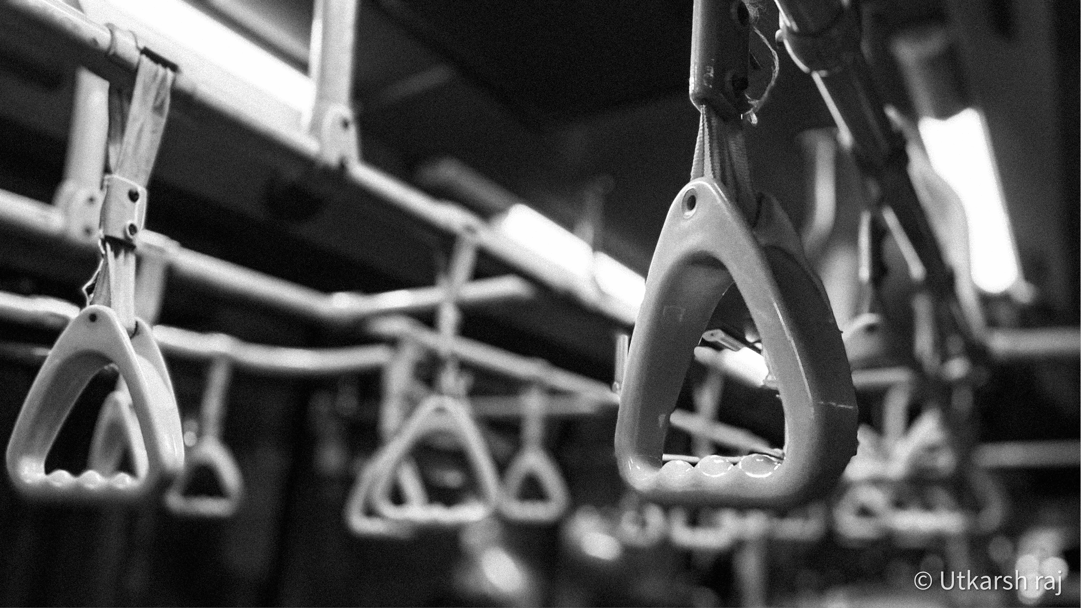 Geometric rows of bus handrails in black and white
