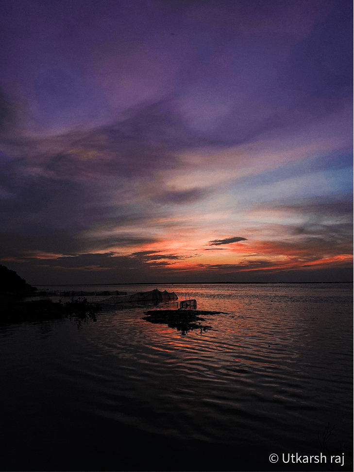 Dramatic purple and orange sunset over open water