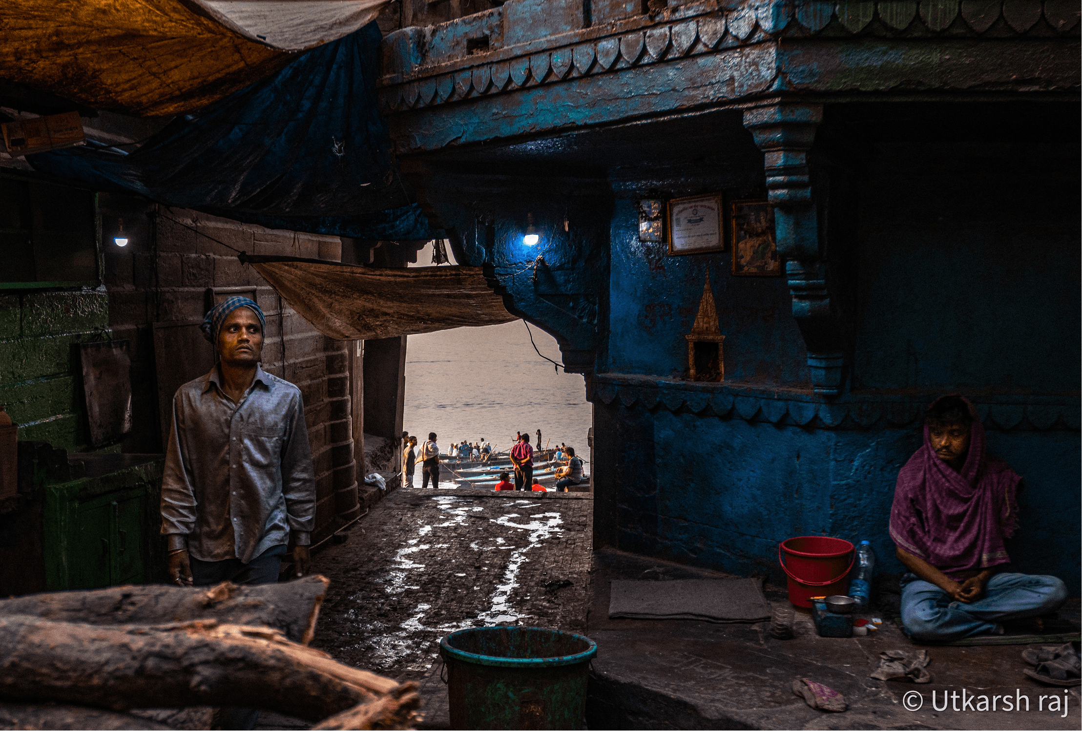 Blue walls of a Varanasi ghat with figures